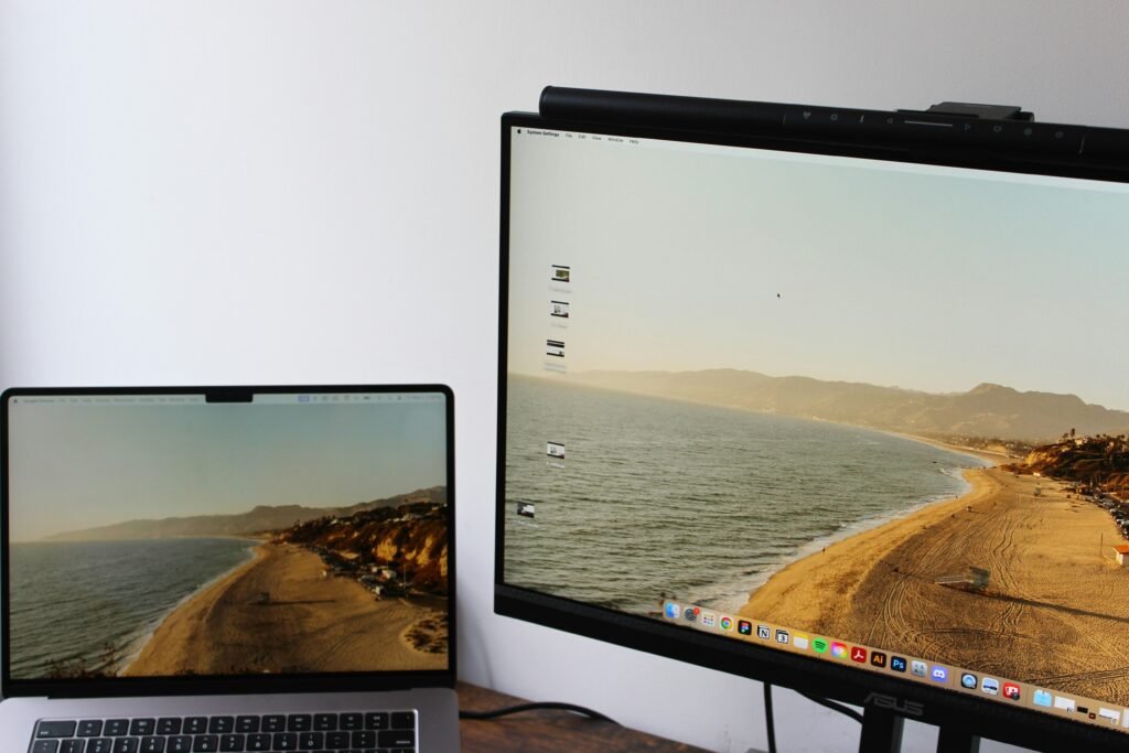 A laptop docked to external monitors on a home office desk, illustrating desktop PC versus laptop setups