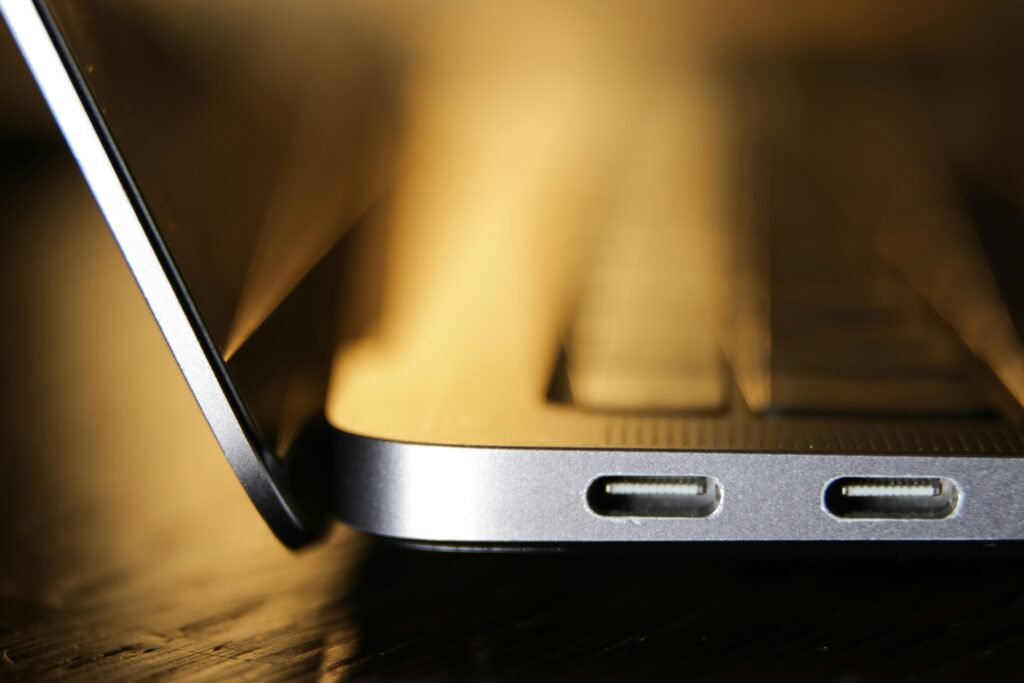 USB-C cable being connected to a laptop, illustrating ports for a hub or docking station
